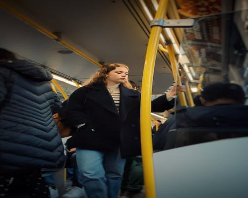 Commuter standing comfortably in public transport